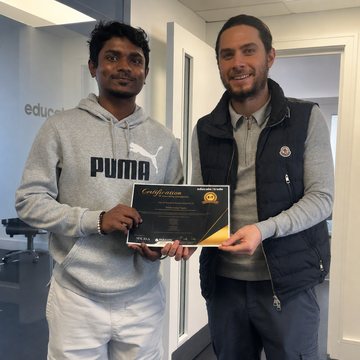 Sam Netto receiving their trading certificate